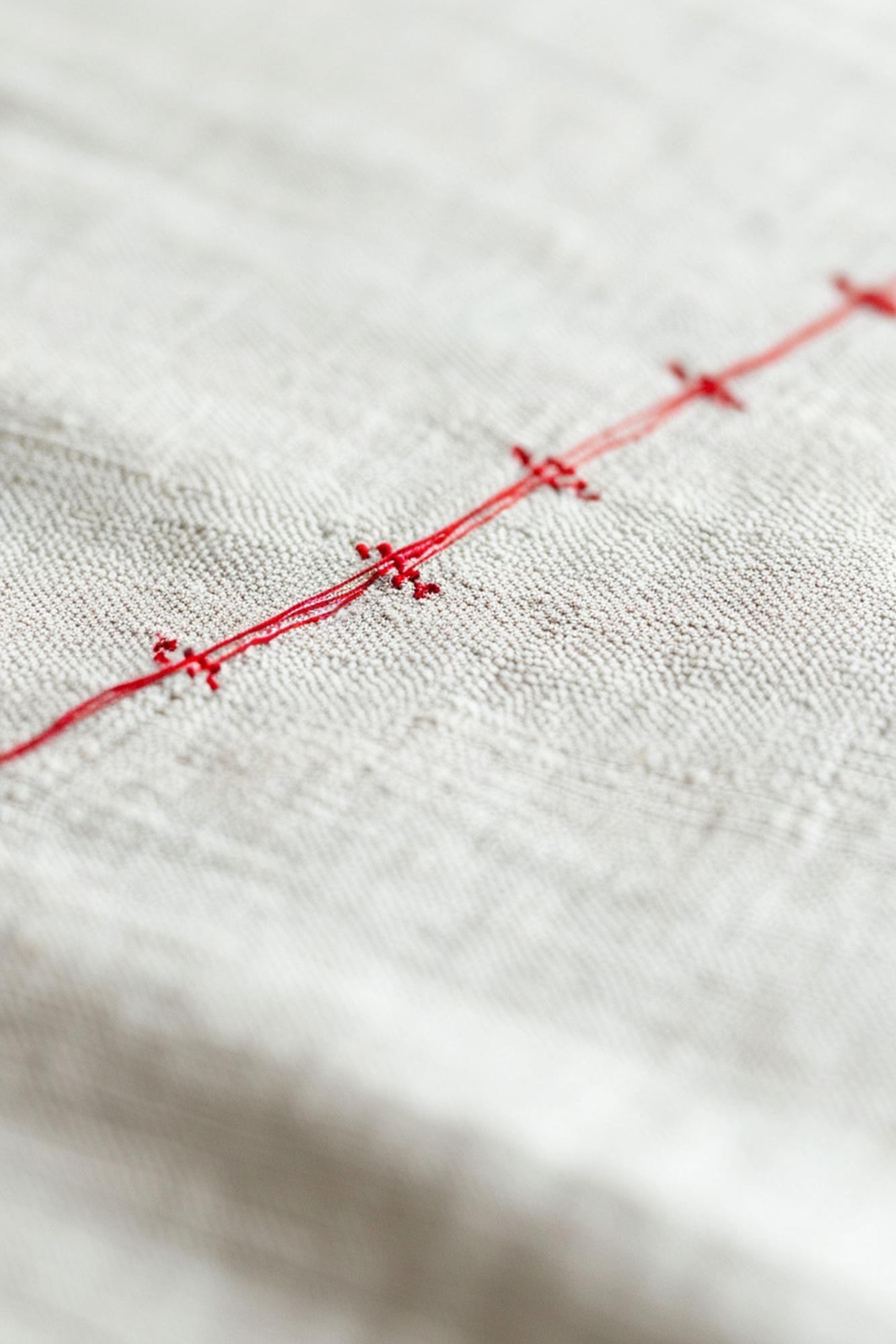 Delicate hand embroidery on neutral linen